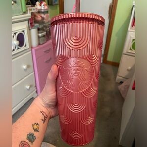 Pink Starbucks cup with straw topper